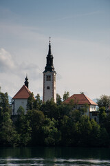 Sticker - A vertical shot of Maria Church near the Lake Bled, Slovenia