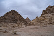 Ruins of the small pyramid of Queen Henutsen with Khafre Pyramids at background, Giza Plateau, Egypt. UNESCO World Heritage