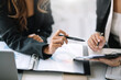 © amnaj - Businesswoman working together brainstorm ideas planning business strategies together in the office.