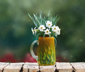 Wall Mural - Narcissus flowers in glass vase on wooden table. Copy space