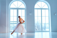 Ballerina In White Tutu And Leotard On Pointe Shoes