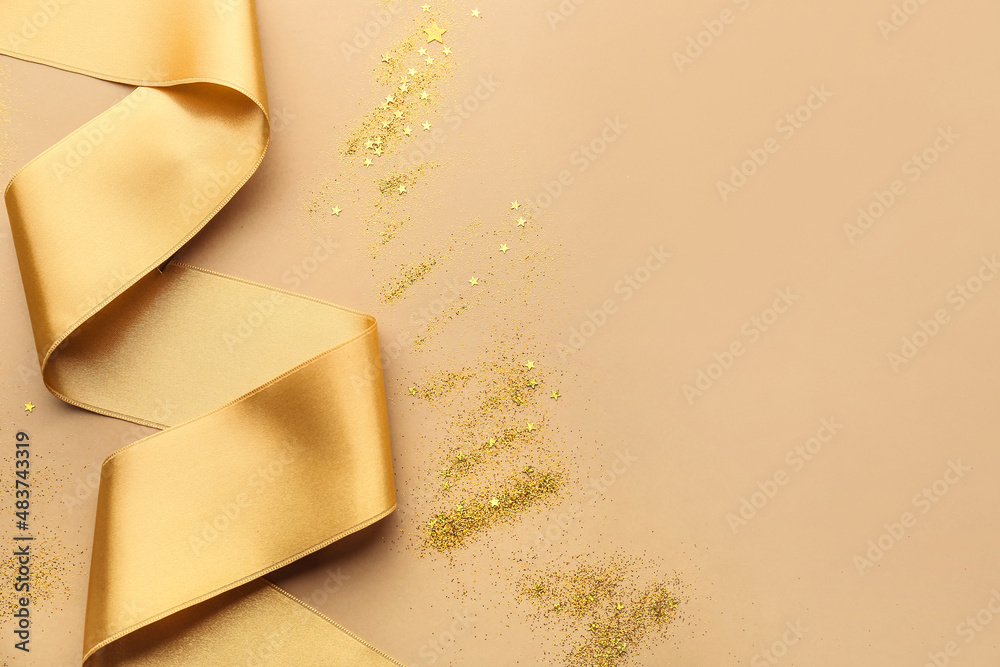 Golden ribbon with glitters on color background