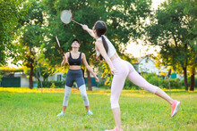 Young Women Playing Badminton Outdoors
