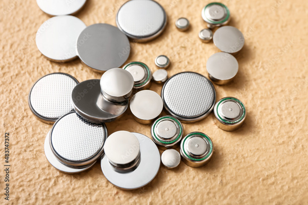 Lithium button cell batteries on beige background