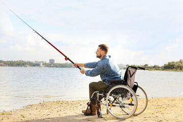 Poster - Man in wheelchair fishing on river