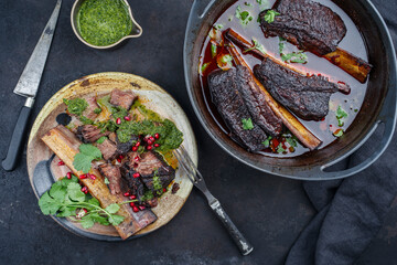 Traditional braised chuck beef ribs in red wine sauce served as close-up in a modern design Dutch oven