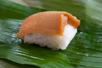 Sticky rice with Thai custard (Khao Nieaw Sang Ka Ya) The local store  normally put a slice of custard on topped of the rice and then wrapped them up in banana leaf.