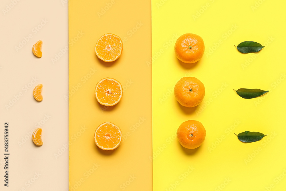 Composition with sweet tangerines  and leaves on color background