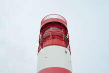 A Low Angle Shot Of A Lighthouse With The White Sky In The Background