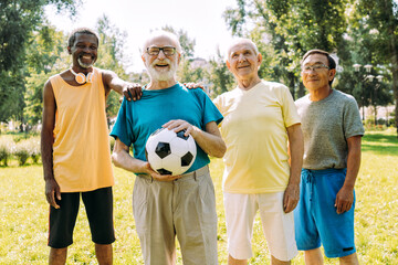 Wall Mural - Group of senior friends playing at the park