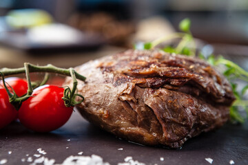 Lamb steak with cherry tomatoes and wine sauce. Delicious healthy traditional food closeup served for lunch in modern gourmet cuisine restaurant