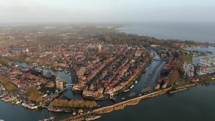 Wall Mural - Aerial view on the historic town Enkhuizen in the Netherlands, situated on the edge of the IJsselmeer lake with historic buildings, towers and churches