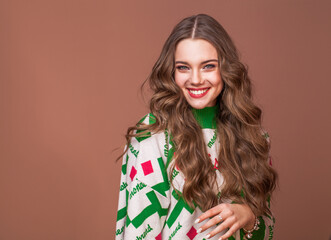 Portrait of a young beautiful teenage girl on a beige isolated background