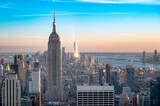 Fototapeta  - city view of Manhattan skyline at sunset with reflecting sun - NYC, USA