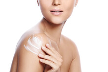 Young And Beautiful Woman With Applying Moisturizing Cream On Her Shoulder