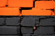 Orange and black brick wall texture background. Damaged, old building with holes. Lines on house wall. Street art detail. Half, dualism. Creative backdrop. Painted stone structure. Copy space