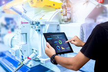 Smart Industry Control Concept.Hands Holding Tablet On Blurred Automation Machine As Background