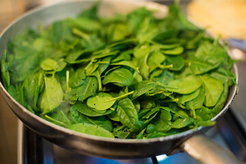 Spinach in a pot with lit fire