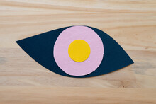 Yellow And Pink Circles On A Ocular Shaped Form On Wood