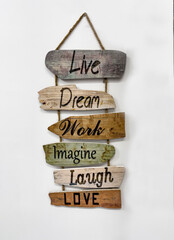 wooden plank signs hung with rope, with positive messages of live, dream, work, laugh and love, on a white background, vertical