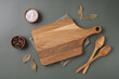 Wood cutting board and napkin on wooden table and spice, pepper, salt.