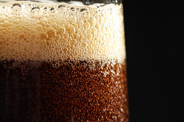 Poster - Glass of refreshing soda drink on black background, closeup