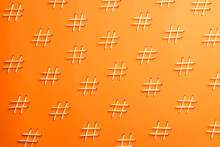 Hashtag Symbols Made Of Wooden Matches On Orange Background, Flat Lay