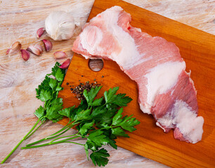 Raw pork cinch ready for cooking on wooden table. Fresh and raw meat