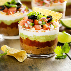 Wall Mural - Seven layer dip in individual cups, mexican appetizer