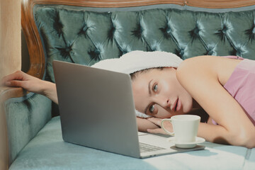 Wall Mural - Beautiful women in bathrobes and towels with coffee and laptop in bedroom after wake up. Sexy carefree models on bed in apartment or hotel room.