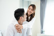 © Kawee - Portrait of Asian new marriage couple sit on bed and look at camera.