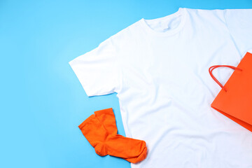 Wall Mural - Blank t-shirt, bag and socks on blue background