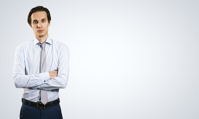 Poster - Business concept with isolated young employee man in white shirt folded his hands on abstract light background with copyspace, mockup