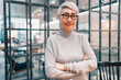© oatawa - Close-up portrait of smiling asian senior businesswoman standing in the office while looking at camera.