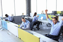 Businessman With Arms Raised Celebrating Success Recived Good News On E-mail In Office.