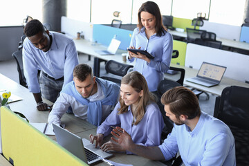 Wall Mural - Team young professionals having casual discussion in office. Executives having friendly discussion during break.