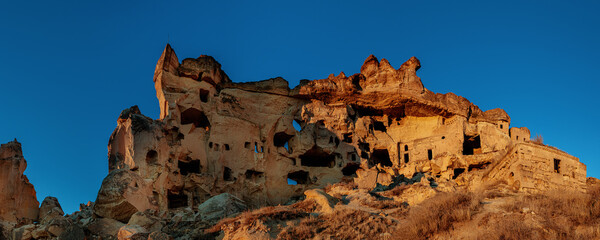 Wall Mural - Cavusin village - Old Greek town in CAPPADOCIA, TURKEY. The old troglodyte settlement, Saint Baptist Monastery, which is one of the oldest building in Cappadocia