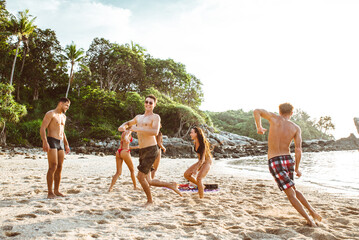 Group of friends having fun on the beach on a lonely island