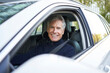 © Westend61 - Smiling elderly man sitting in car on road trip