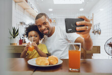 Happy African American Fther And Little Kid Boy Taking Selfie With Smartphone