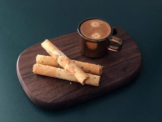 Canvas Print - An egg rolls with coffee on a wooden board