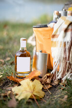 Close-up Of Bottle And Flask On The Grass At Picnic. Bottle With Blank Label To Copy Paste. Mockup Image For Branding Drink