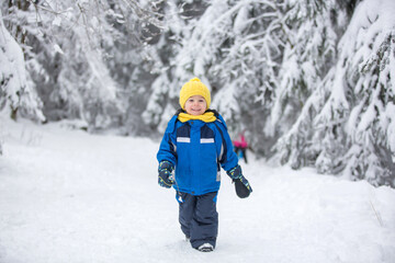 Canvas Print - Sweet happy child, playing in deep snow