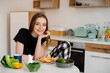 © rostyslav84 - Young beautiful vegetarian girl dressed in pajamas eating fruits and vegetables for breakfast at home in the kitchen