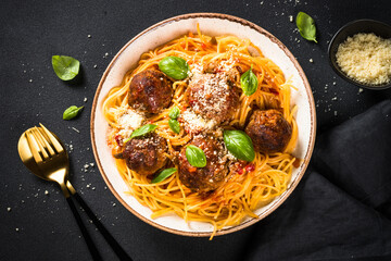 Wall Mural - Pasta with Meatballs in tomato sauce on dark stone table. Traditional italian pasta.