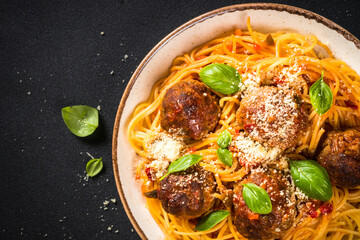 Sticker - Pasta with Meatballs in tomato sauce on dark stone table. Top view with copy space. Close up.