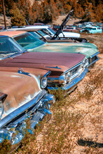 Rusty Old Cars Under A Blue Sky. Old Vintage Vehicles In The Countryside