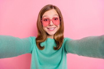 Sticker - Photo of cheerful girl wear turquoise sweater heart glasses tacking selfie isolated pink color background