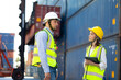 © NVB Stocker - Man manager and woman Supervisor dock cargo checking  and control loading Containers box at container yard port of import and export goods. Unity and teamwork concept