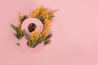 Paper art to 8 March, Happy women's day celebrating. Number eight cut in the paper against fresh mimosa Flowers on a Calming Coral color background.